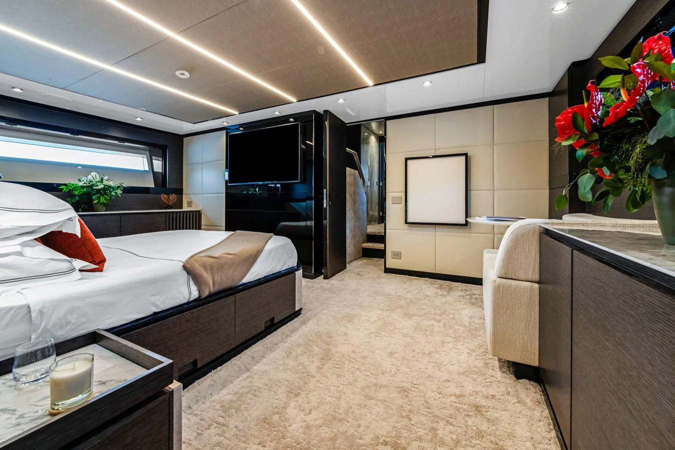 a bedroom with a bed and a tv aboard MARTITA Yacht for Sale