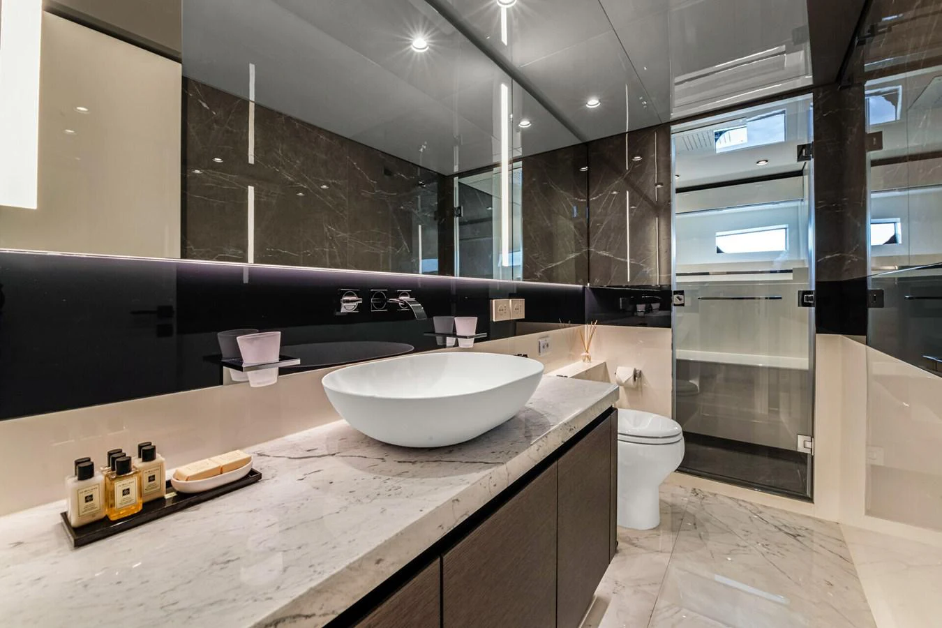 a bathroom with a sink and a large mirror aboard MARTITA Yacht for Sale