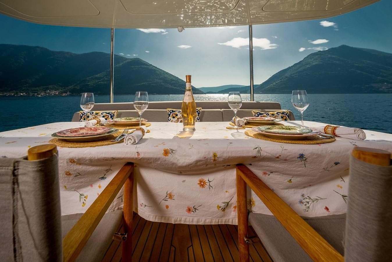 a table set with food and wine aboard AVVENTURA Yacht for Sale