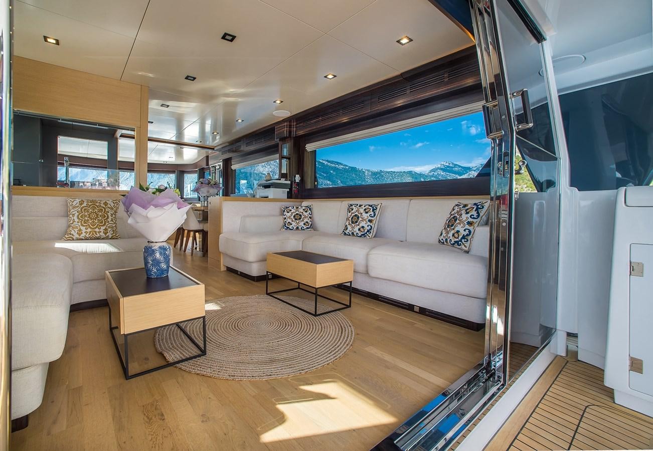 a living room with a large screen aboard AVVENTURA Yacht for Sale