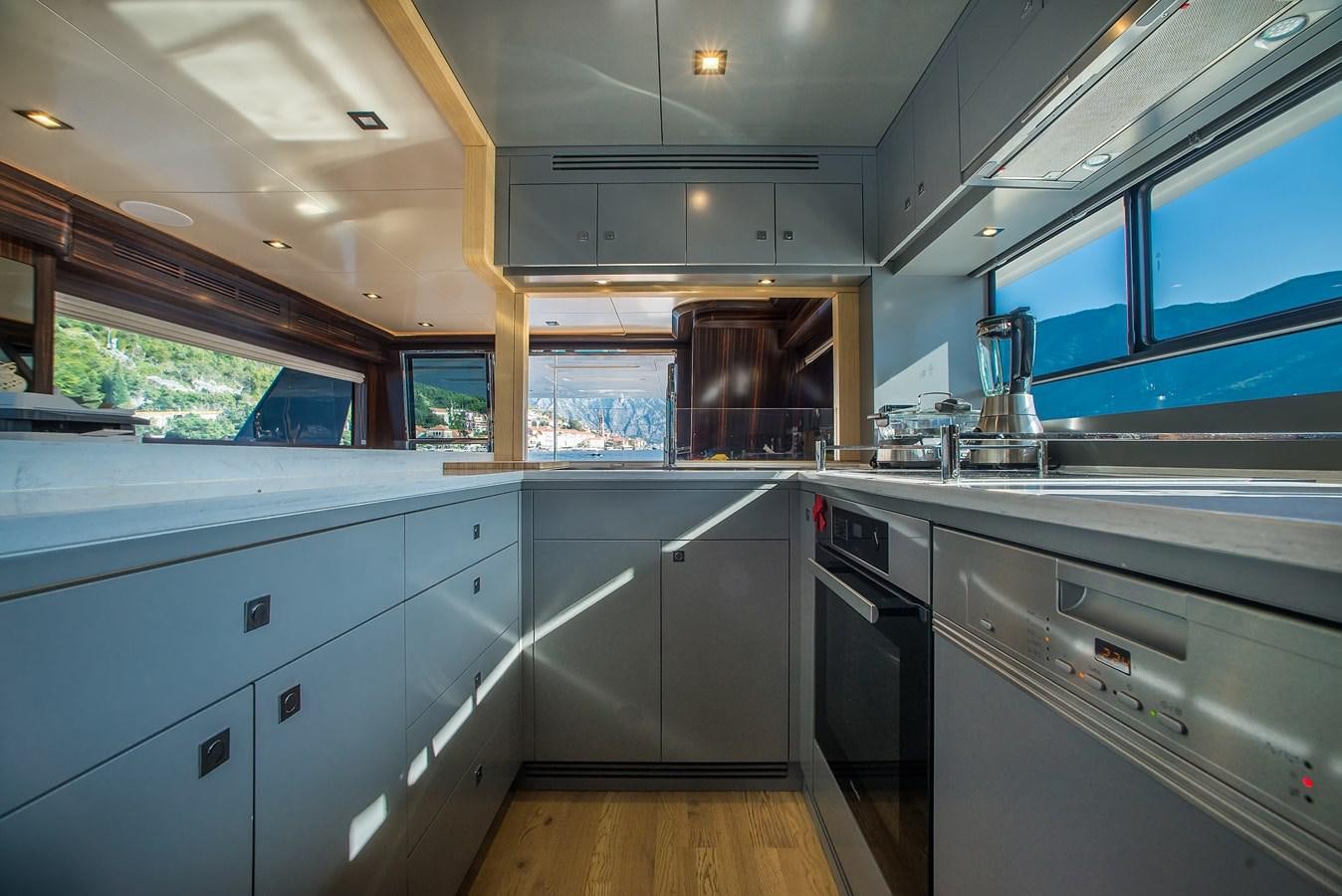 a kitchen with white cabinets aboard AVVENTURA Yacht for Sale