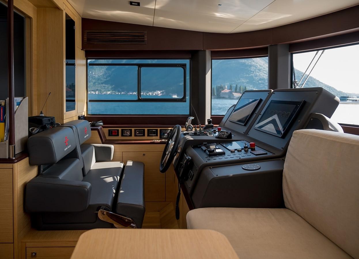a room with a couch and a television aboard AVVENTURA Yacht for Sale