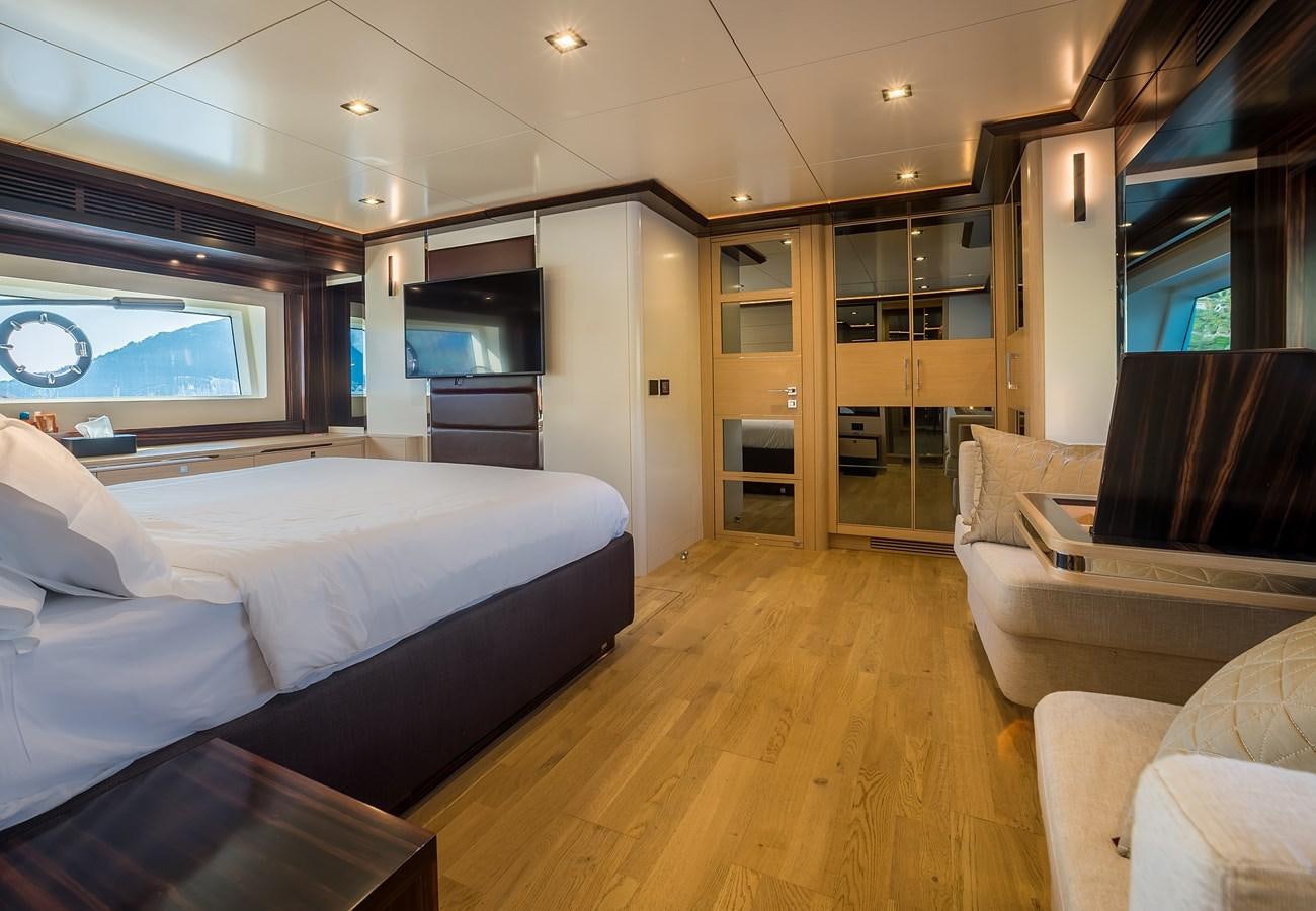 a bedroom with a bed and a tv aboard AVVENTURA Yacht for Sale