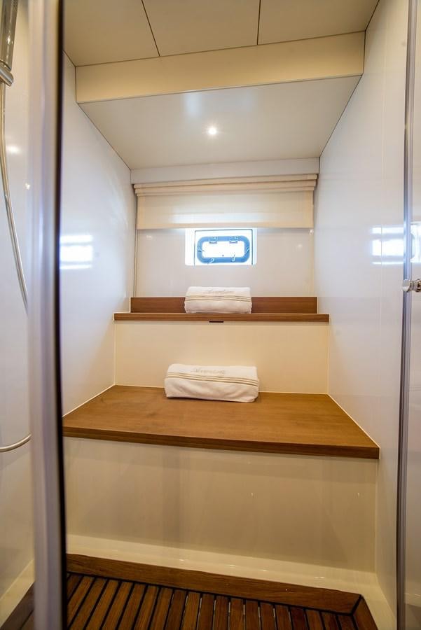a white room with a wooden shelf aboard AVVENTURA Yacht for Sale