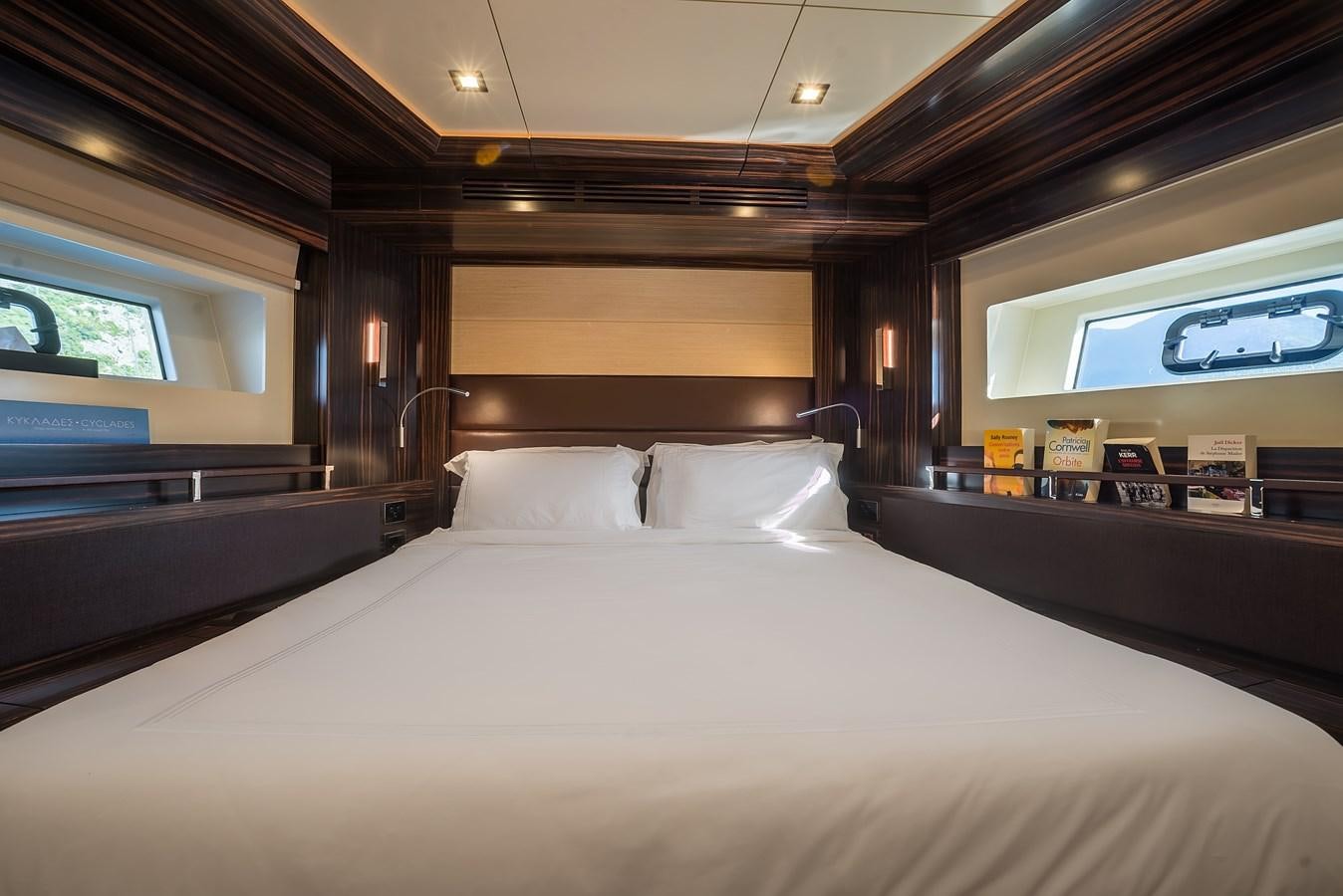 a bed with white sheets aboard AVVENTURA Yacht for Sale