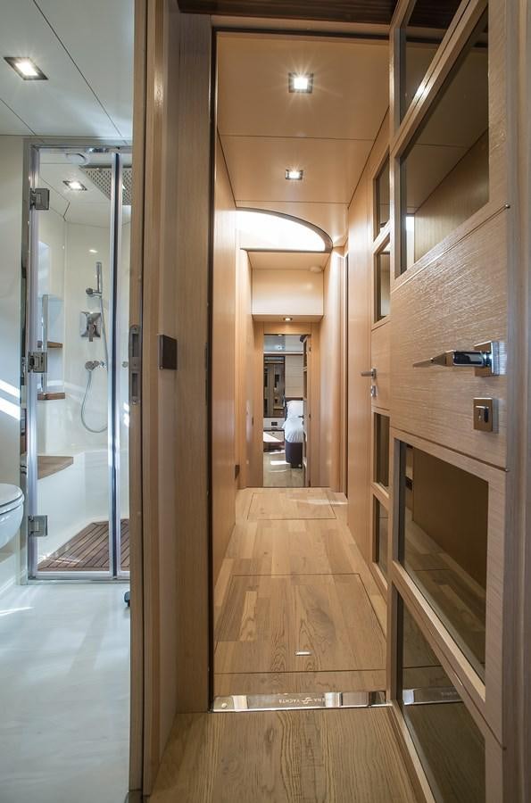 a hallway with glass doors aboard AVVENTURA Yacht for Sale