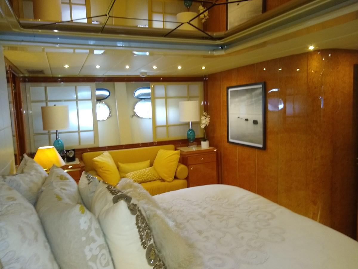 a room with a bed and a lamp aboard ALCHEMIST Yacht for Sale