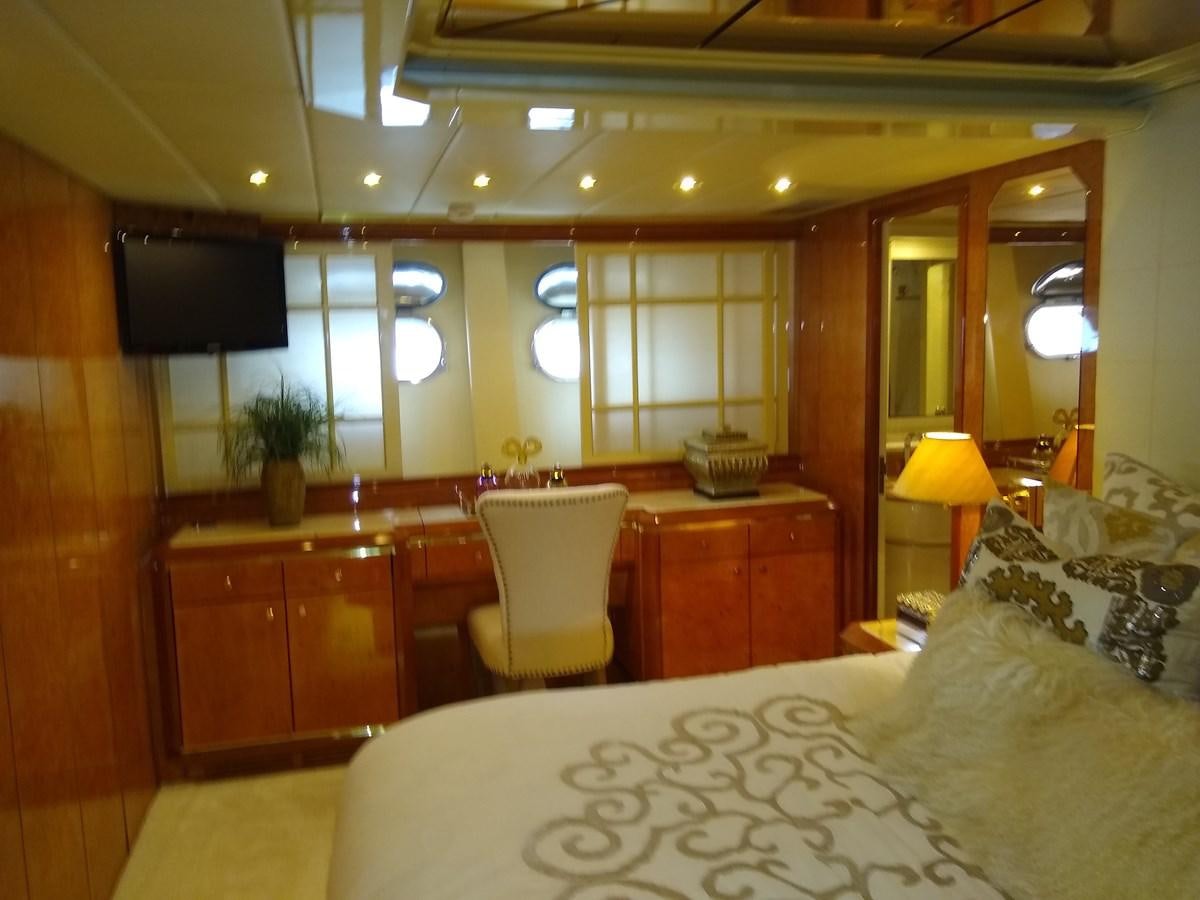 a bedroom with a large mirror aboard ALCHEMIST Yacht for Sale