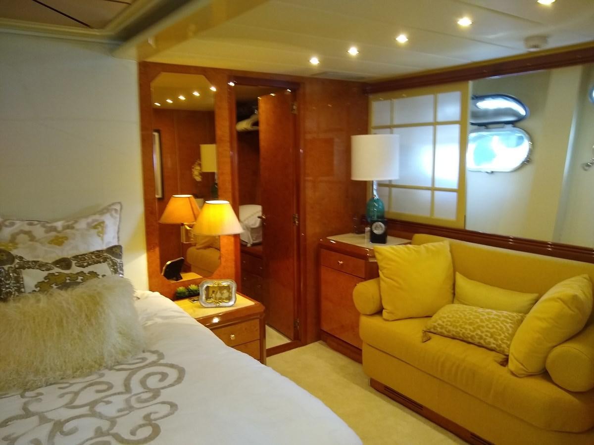 a bedroom with a bed and a desk aboard ALCHEMIST Yacht for Sale