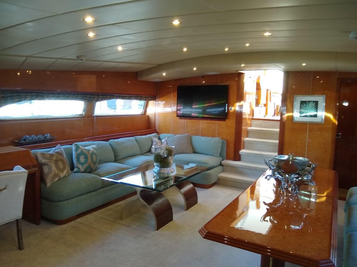 a living room with a couch and a table aboard ALCHEMIST Yacht for Sale