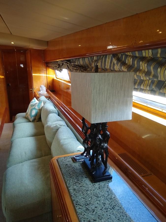 a room with a couch and a lamp aboard ALCHEMIST Yacht for Sale