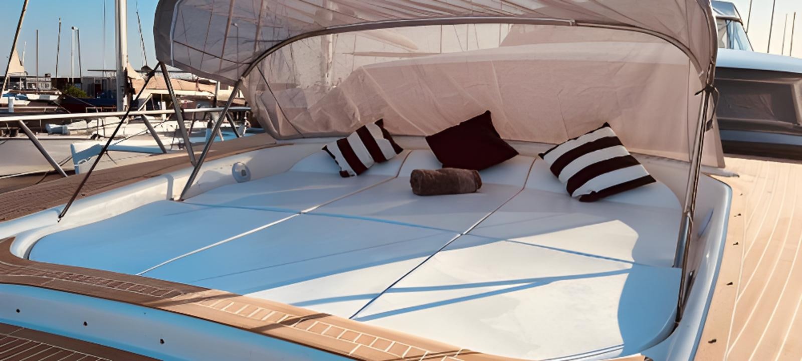 a bed with pillows on it aboard VARUNA Yacht for Sale