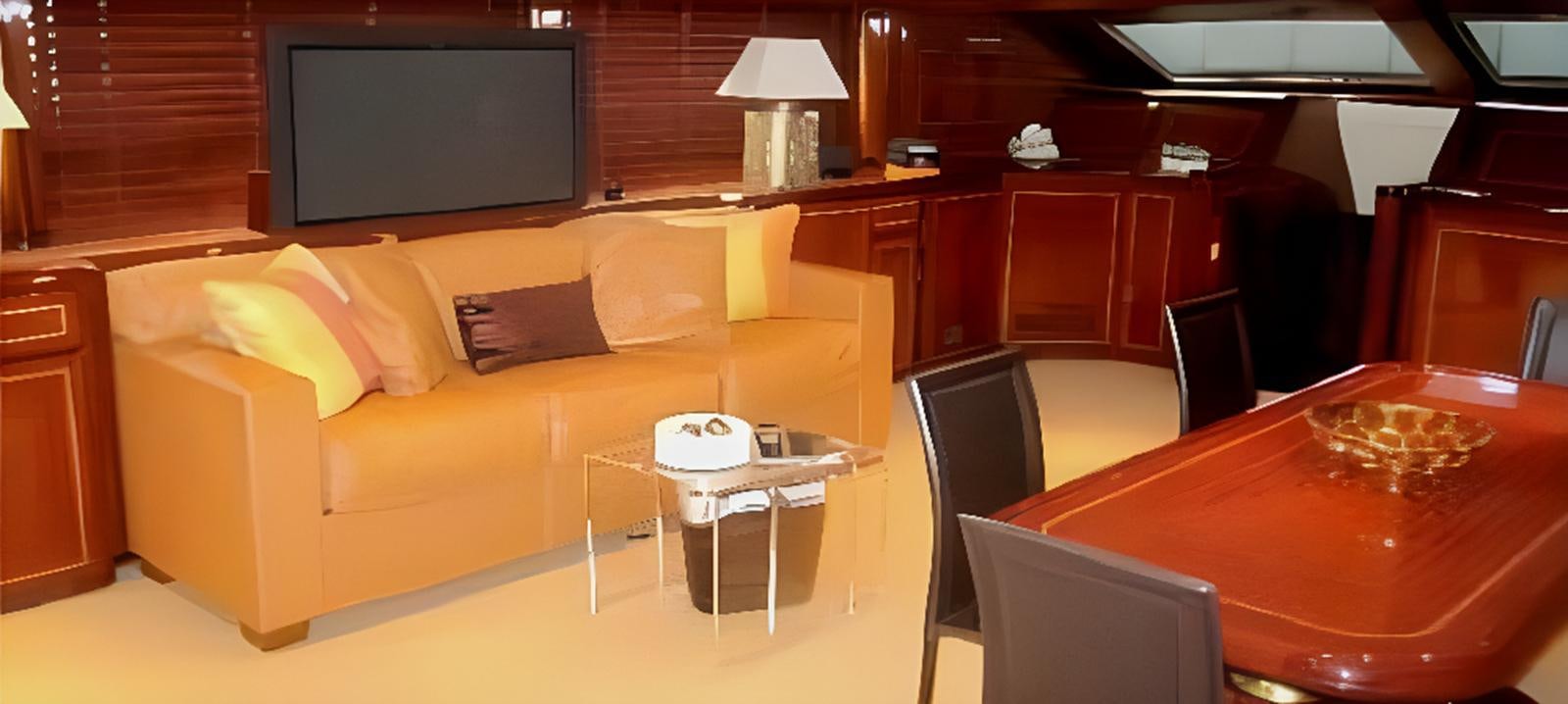 a living room with a couch and a television aboard VARUNA Yacht for Sale