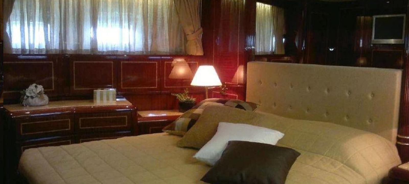 a room with a bed and a desk aboard VARUNA Yacht for Sale