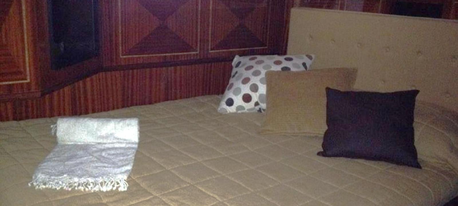 a bed with pillows aboard VARUNA Yacht for Sale