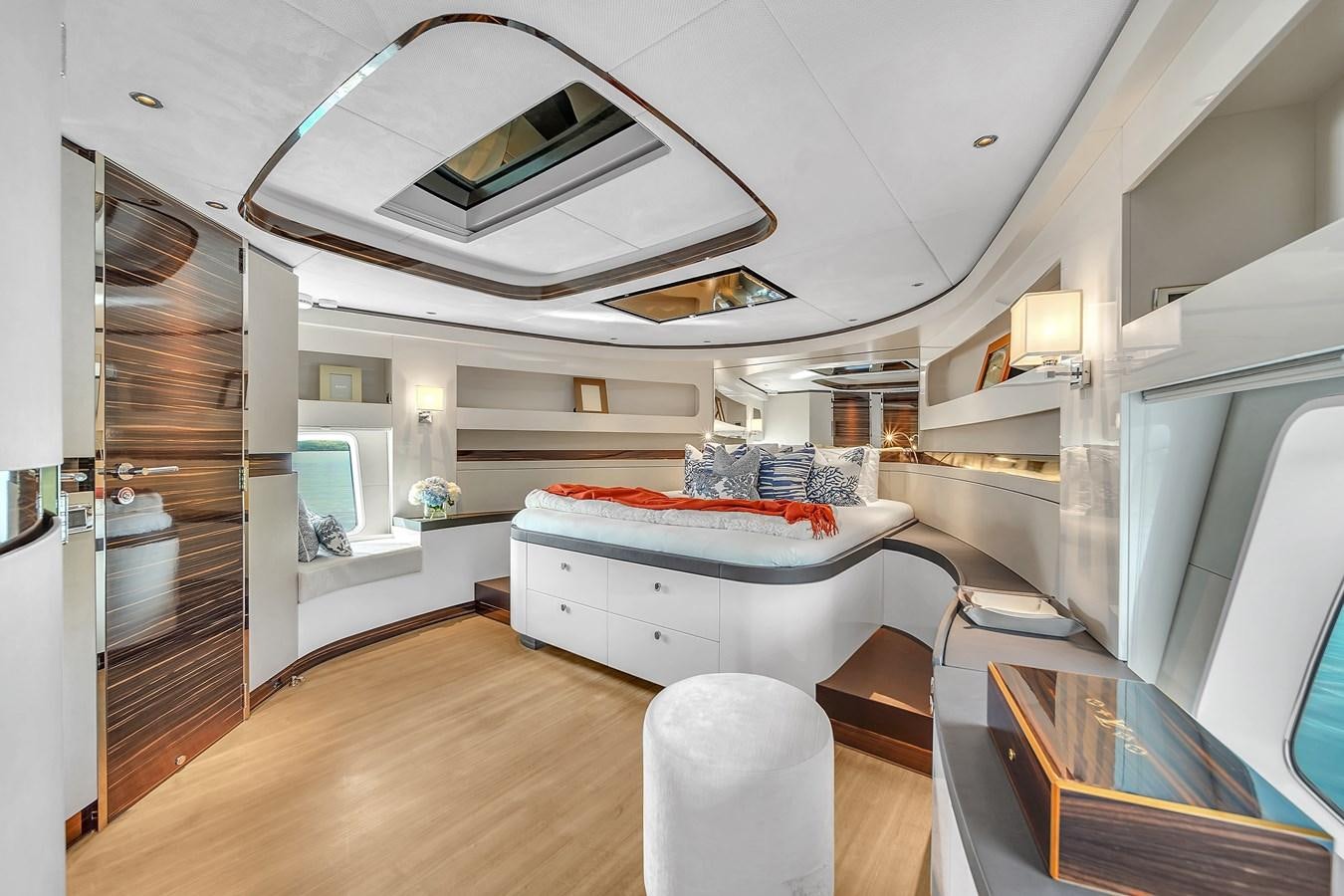 a modern looking bedroom with a large bed and a large mirror aboard MADDAMC2 Yacht for Sale