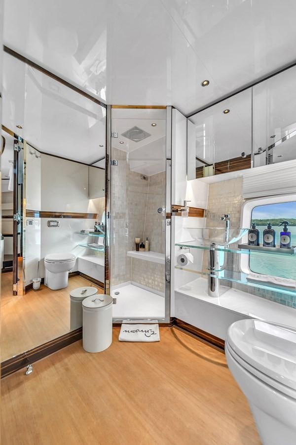 a bathroom with a glass shower aboard MADDAMC2 Yacht for Sale