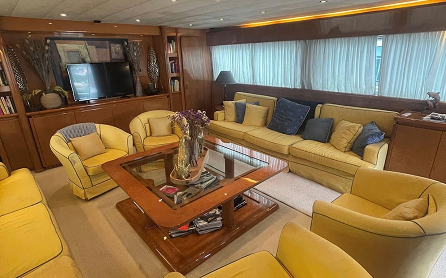 a living room with a table and couches aboard IT'S A DREAM Yacht for Sale