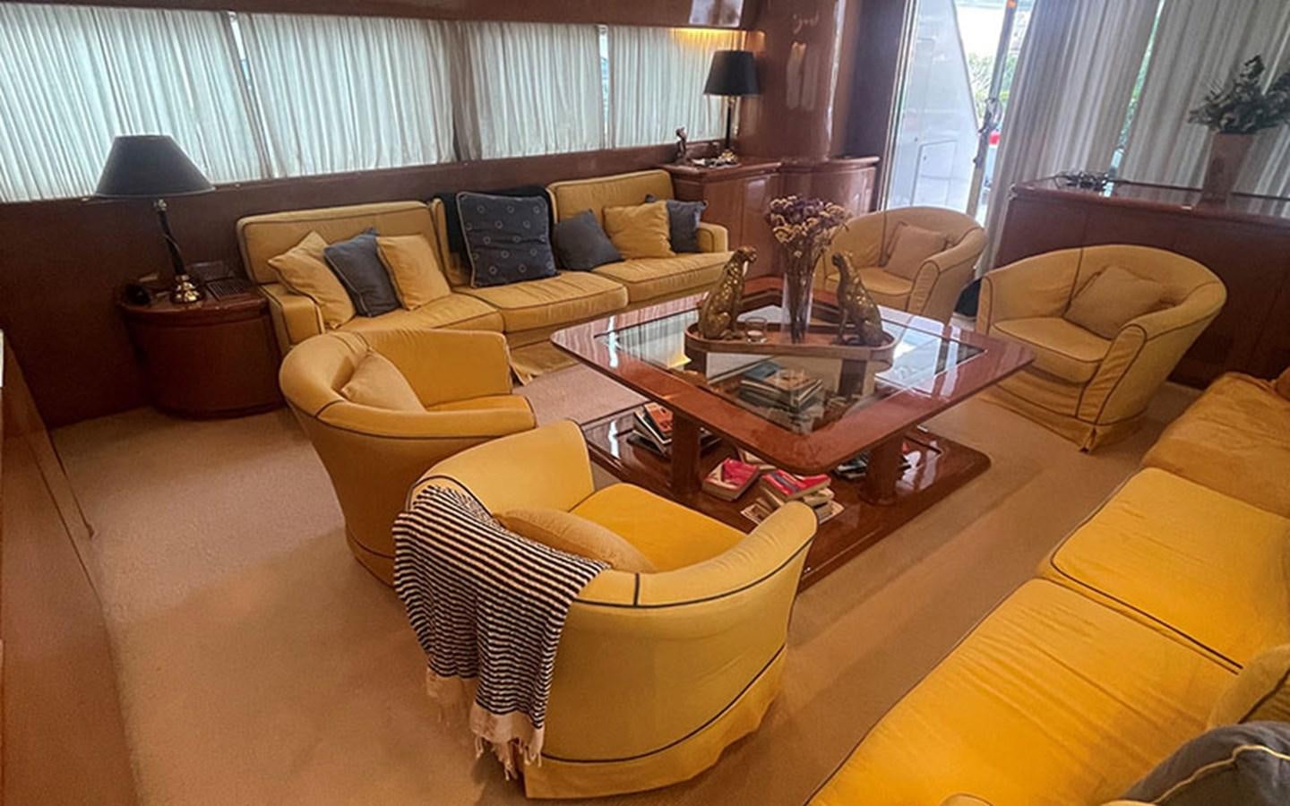 a living room with yellow furniture aboard IT'S A DREAM Yacht for Sale
