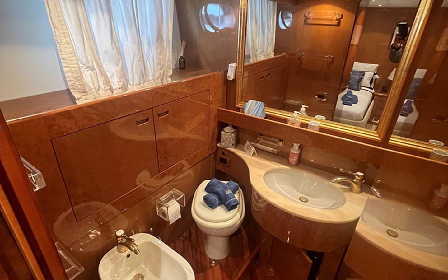 a bathroom with a toilet and sink aboard IT'S A DREAM Yacht for Sale
