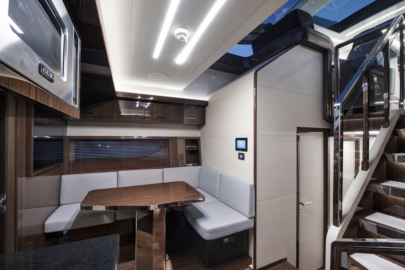 a room with a table and chairs aboard DEMO Yacht for Sale