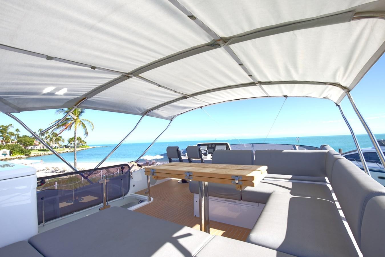a boat with a table and chairs aboard HIDE OUT Yacht for Sale