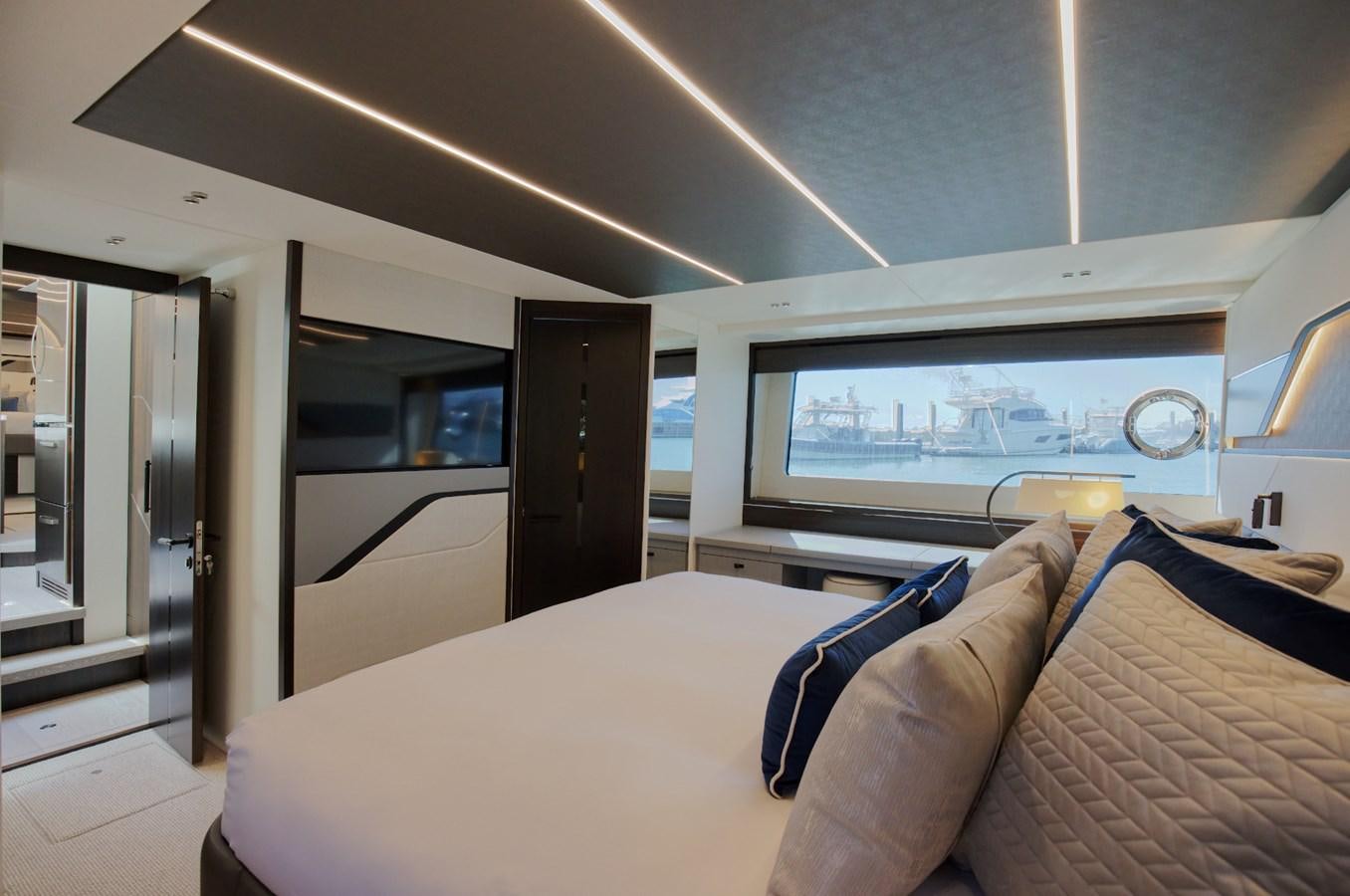 a room with a couch and a tv on the wall aboard HIDE OUT Yacht for Sale