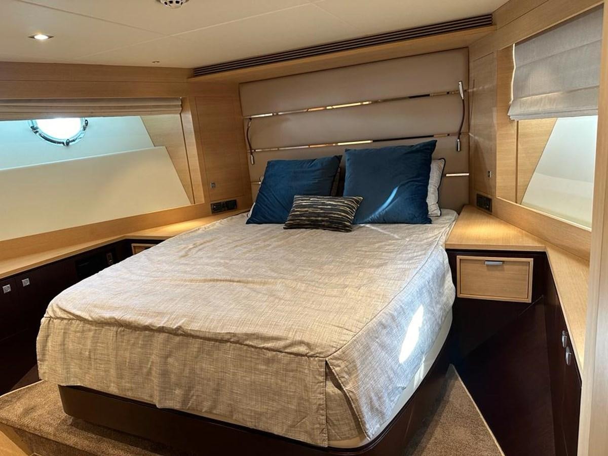 a bed with blue pillows aboard BLACK SOIL Yacht for Sale