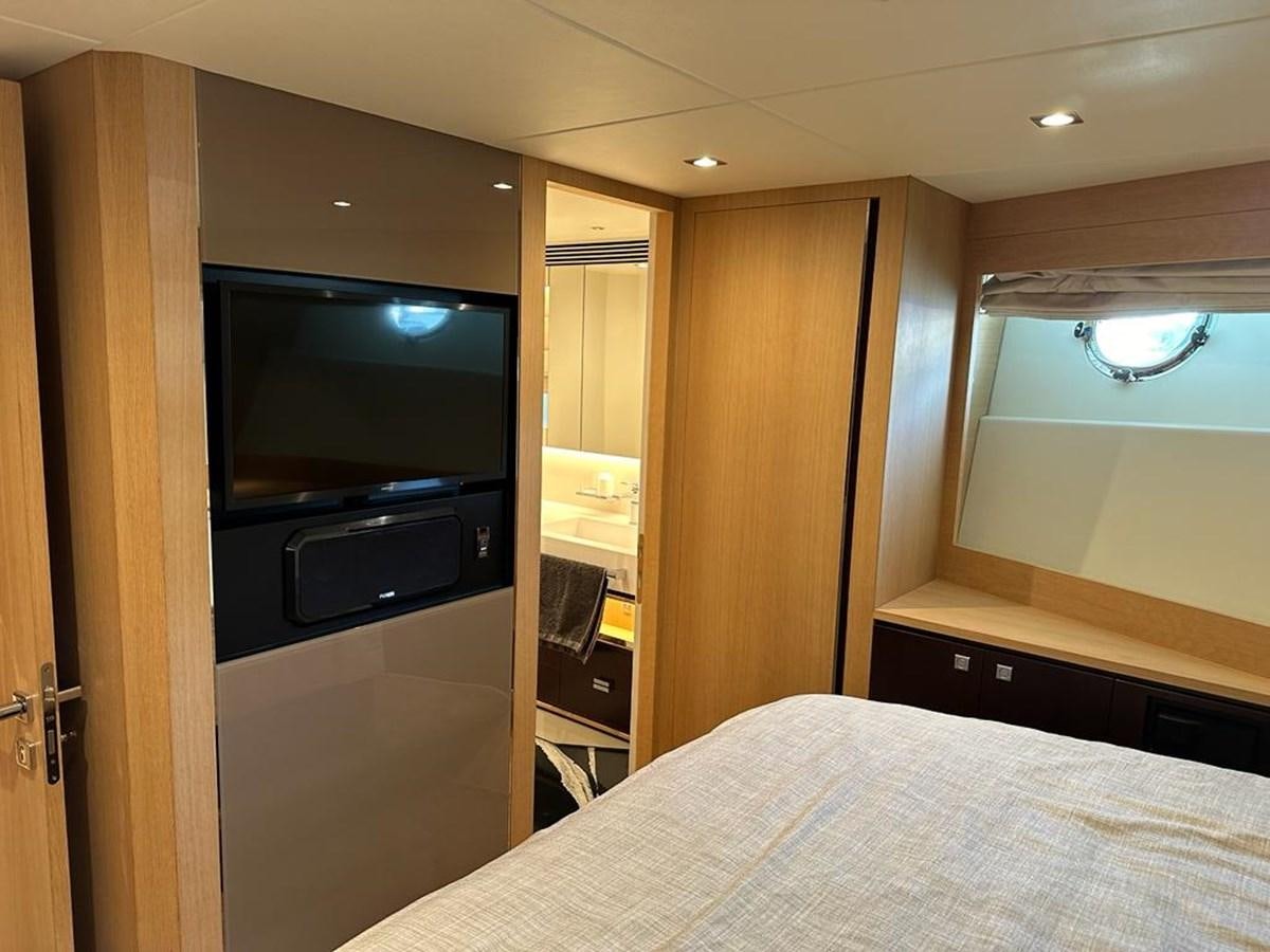 a bedroom with a tv and a bed aboard BLACK SOIL Yacht for Sale