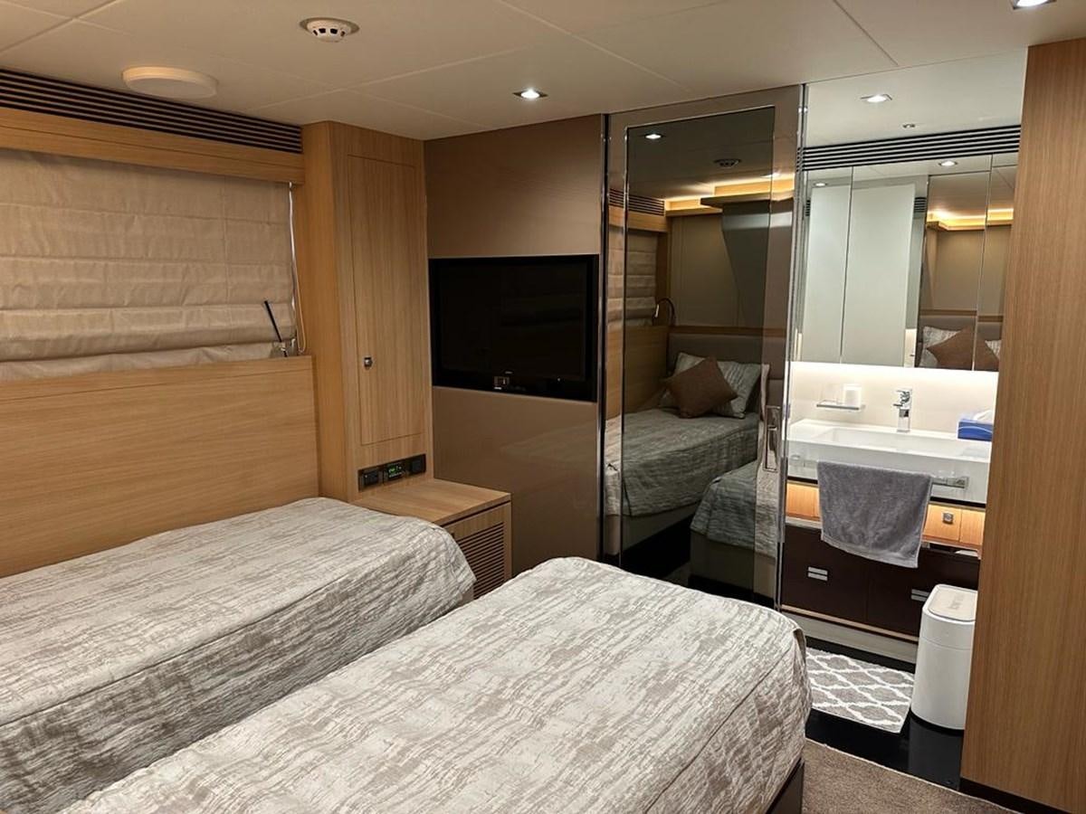 a hotel room with a bed and a tv aboard BLACK SOIL Yacht for Sale