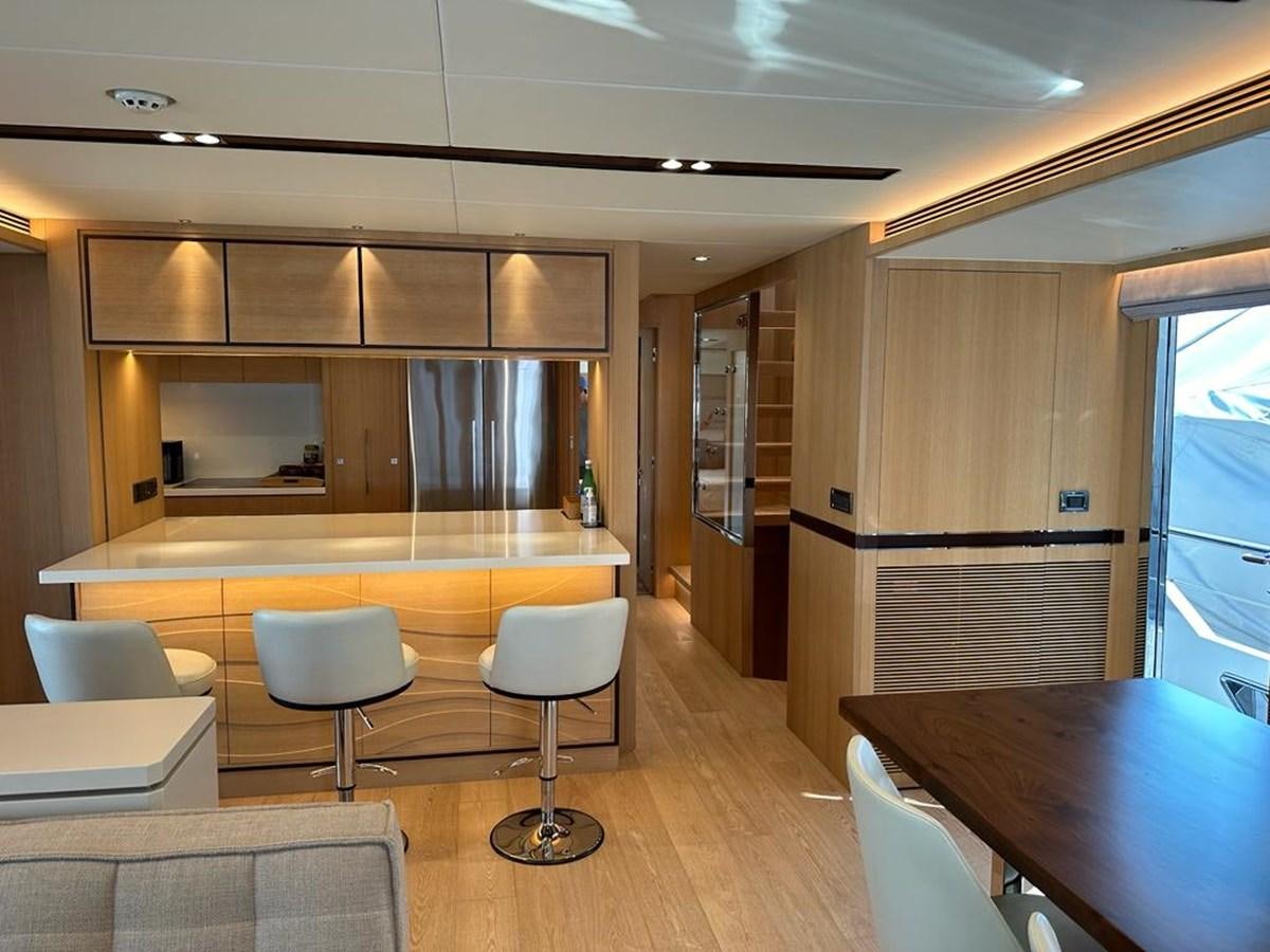a room with tables and chairs aboard BLACK SOIL Yacht for Sale