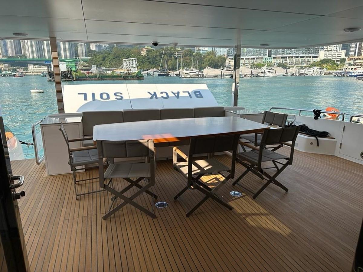 a table on a deck overlooking a body of water aboard BLACK SOIL Yacht for Sale