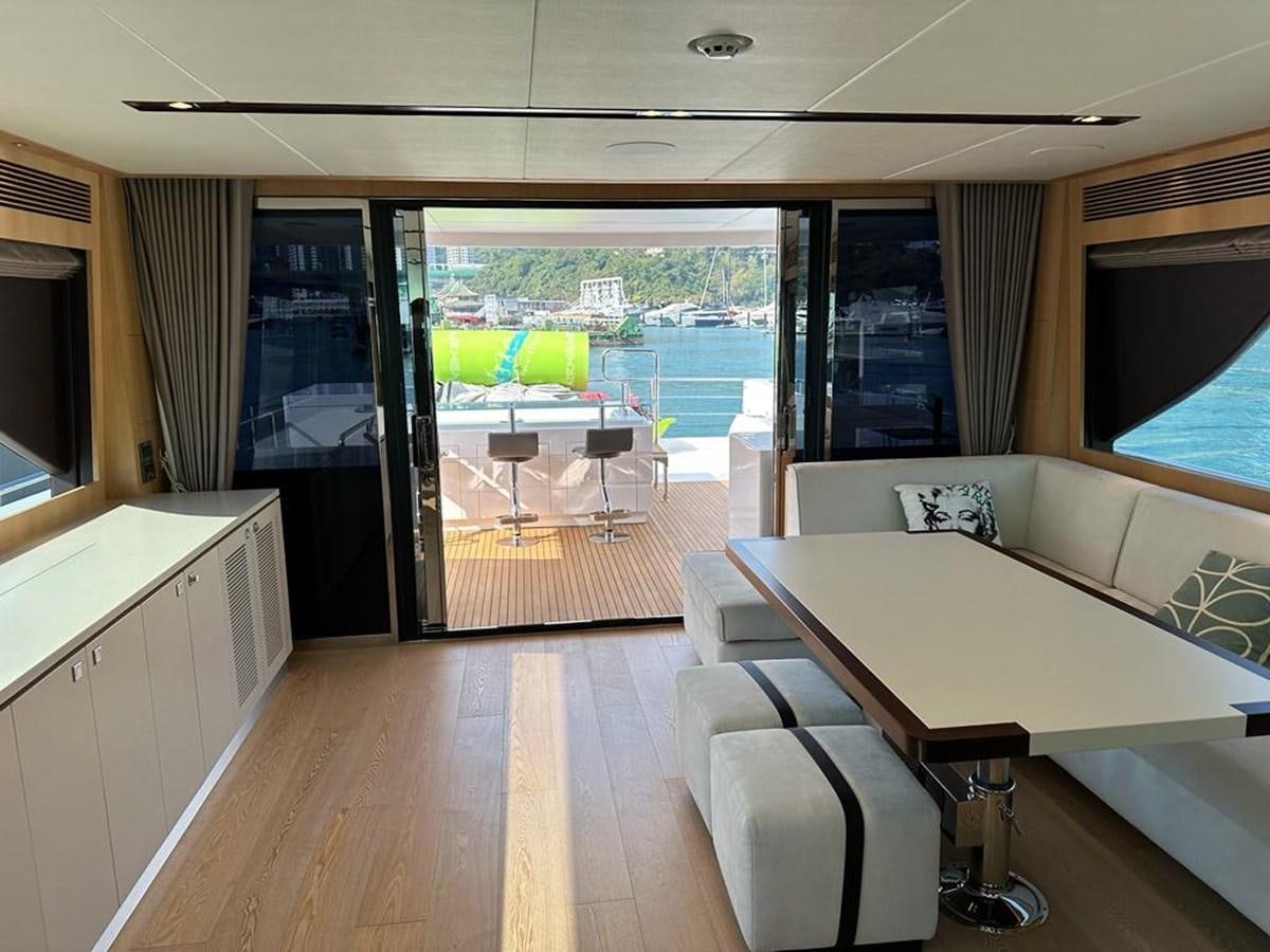a room with a table and chairs aboard BLACK SOIL Yacht for Sale