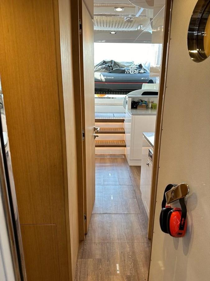 a hallway with a door and a boat in the background aboard BLACK SOIL Yacht for Sale
