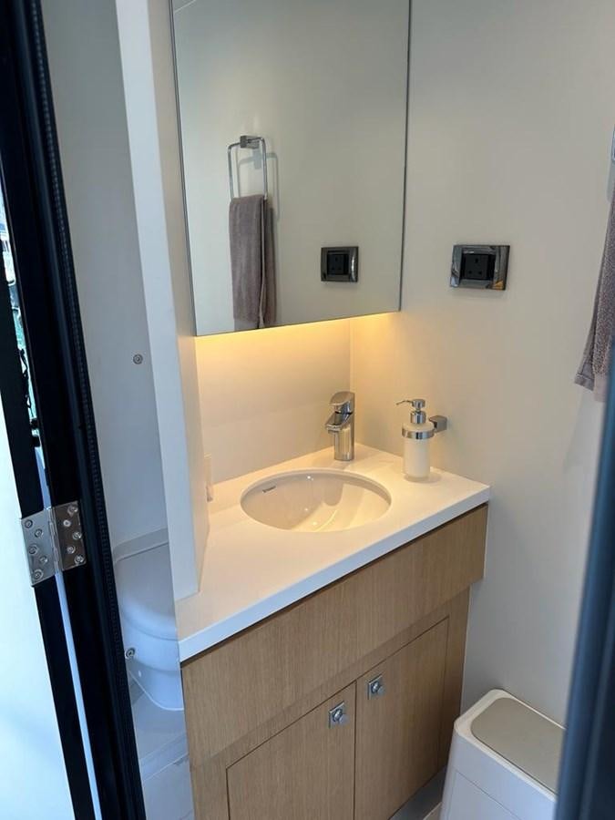 a bathroom with a sink and mirror aboard BLACK SOIL Yacht for Sale