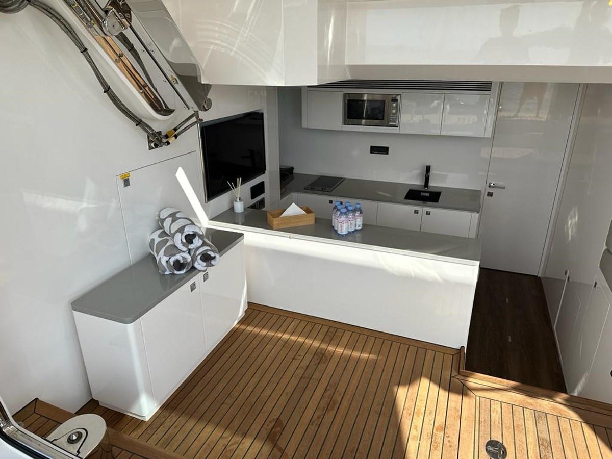 a kitchen with a sink and a microwave aboard BLACK SOIL Yacht for Sale