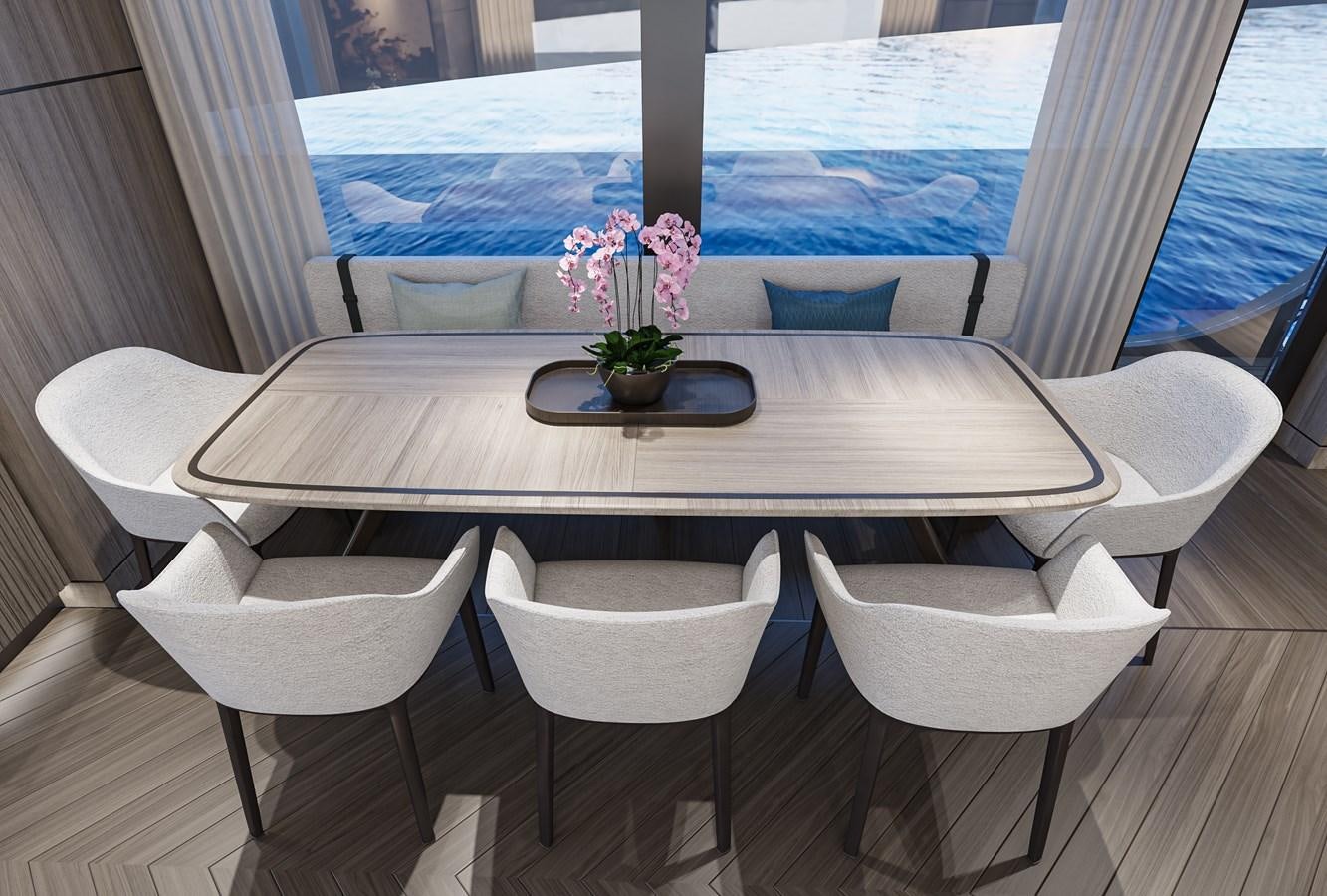 a table with chairs around it aboard X90 FAST Yacht for Sale