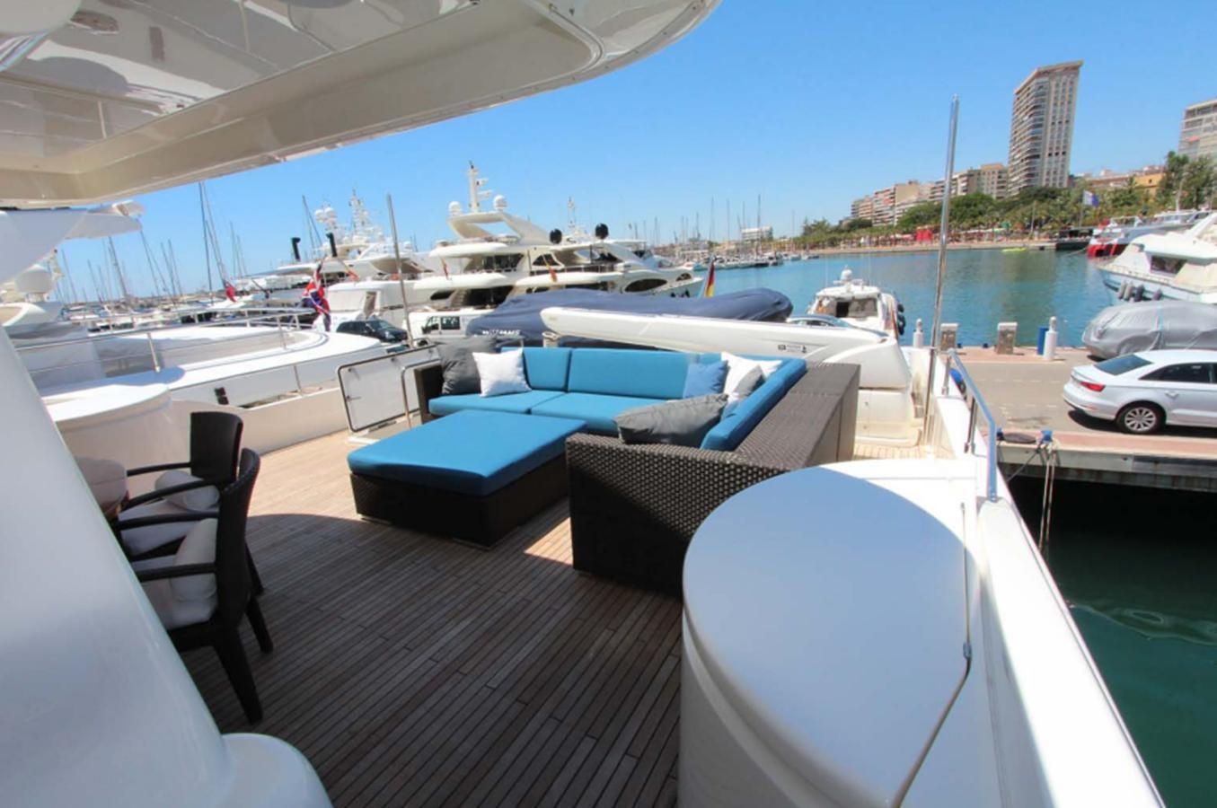a deck with a couch and chairs on it and a body of water in the background aboard ALL WE NEED FOR TODAY Yacht for Sale