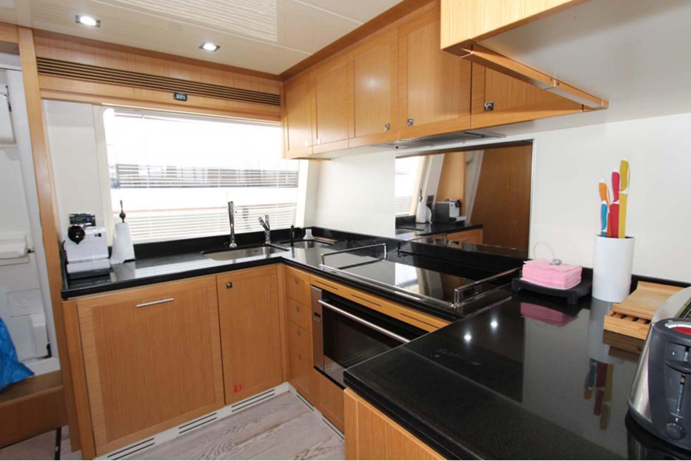 a kitchen with wooden cabinets aboard ALL WE NEED FOR TODAY Yacht for Sale