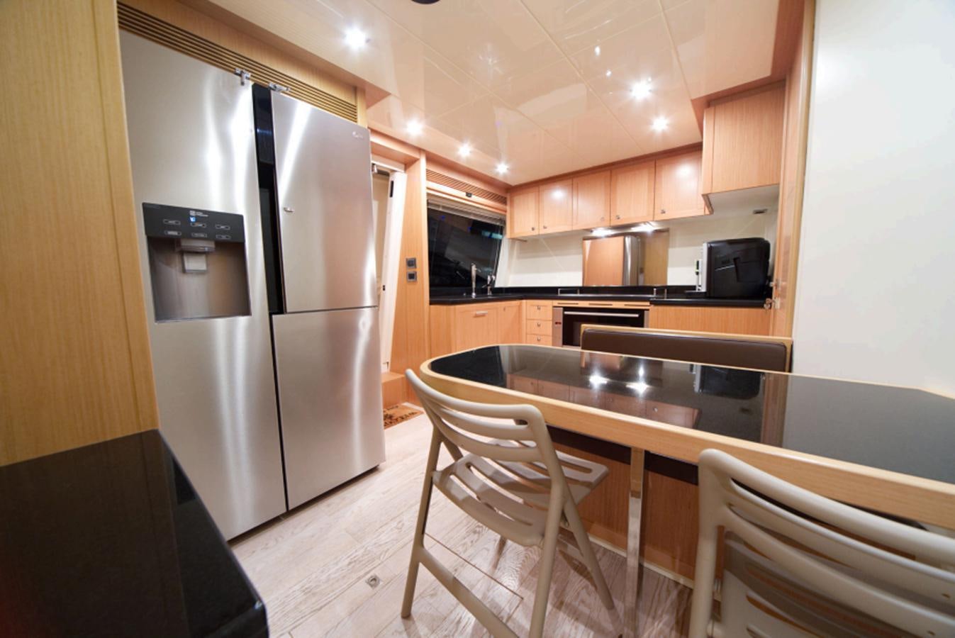 a kitchen with a stainless steel refrigerator aboard ALL WE NEED FOR TODAY Yacht for Sale
