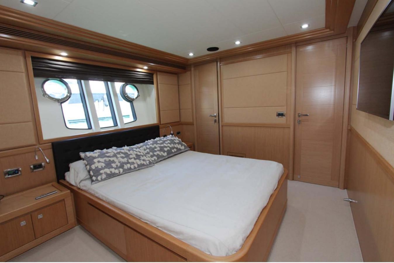 a bedroom with a bed and a window aboard ALL WE NEED FOR TODAY Yacht for Sale