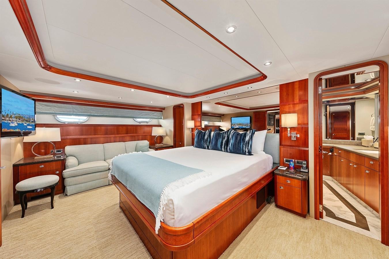 a room with a bed and a couch aboard DESPERADO Yacht for Sale