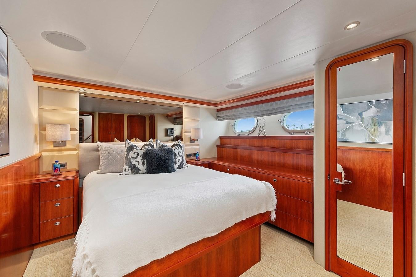 a bedroom with a bed and a mirror aboard DESPERADO Yacht for Sale