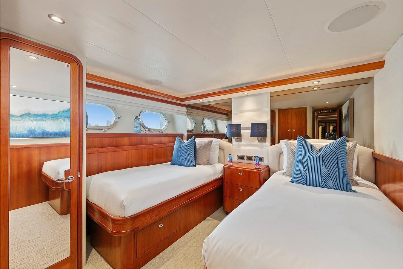 a room with a bed and a mirror aboard DESPERADO Yacht for Sale