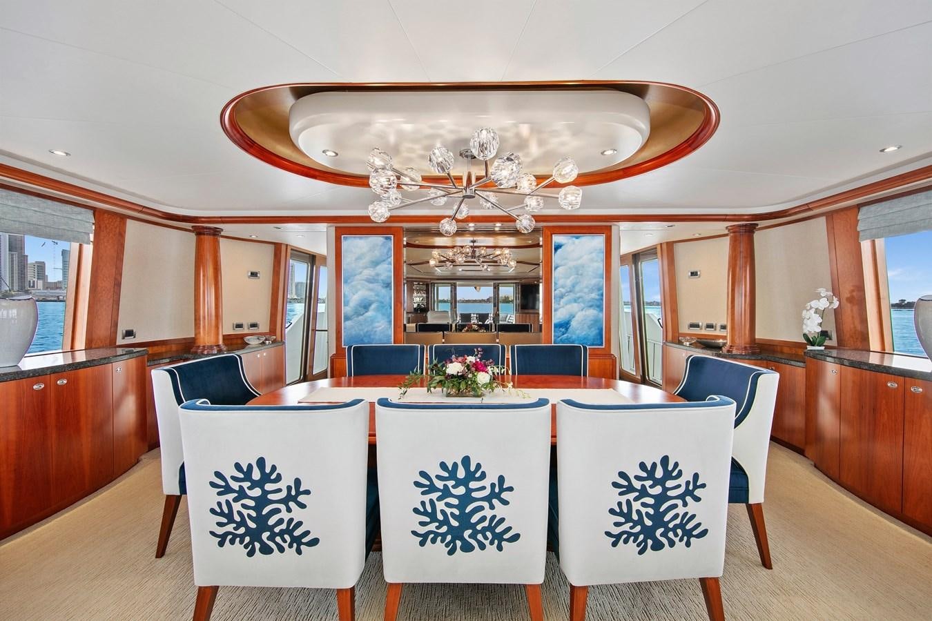 a dining room with a chandelier aboard DESPERADO Yacht for Sale