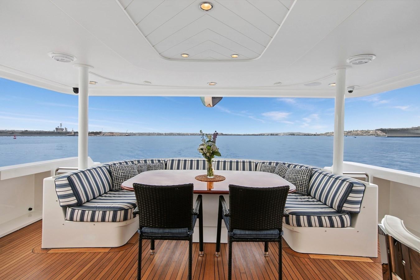a table and chairs on a deck aboard DESPERADO Yacht for Sale