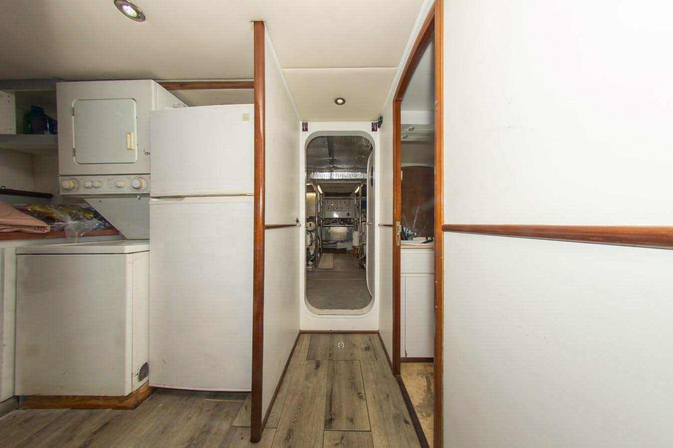 a kitchen with a refrigerator and a microwave aboard OLD SPORT II Yacht for Sale