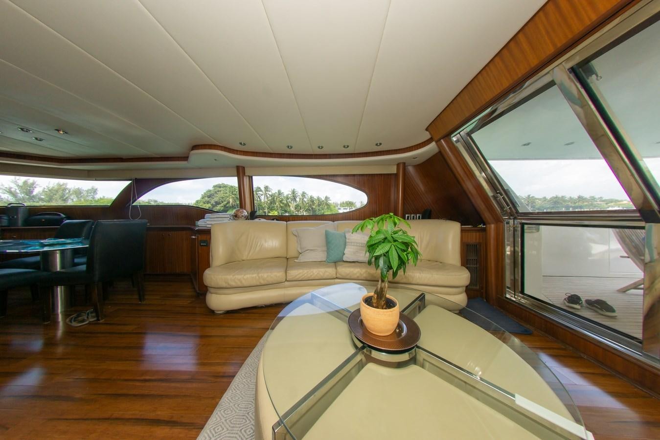 a living room with a table and couches aboard OLD SPORT II Yacht for Sale