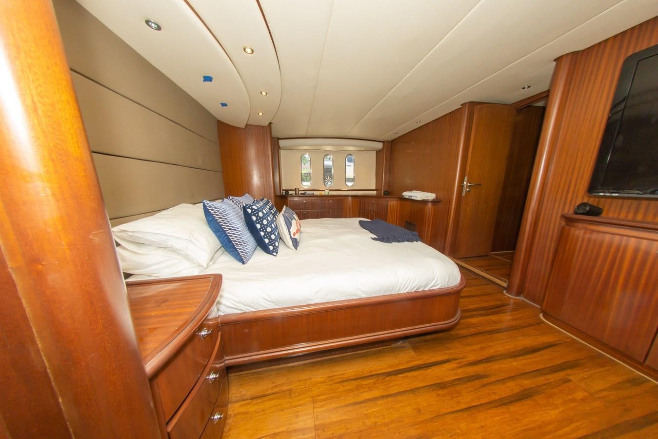 a room with a bed and a wood door aboard OLD SPORT II Yacht for Sale