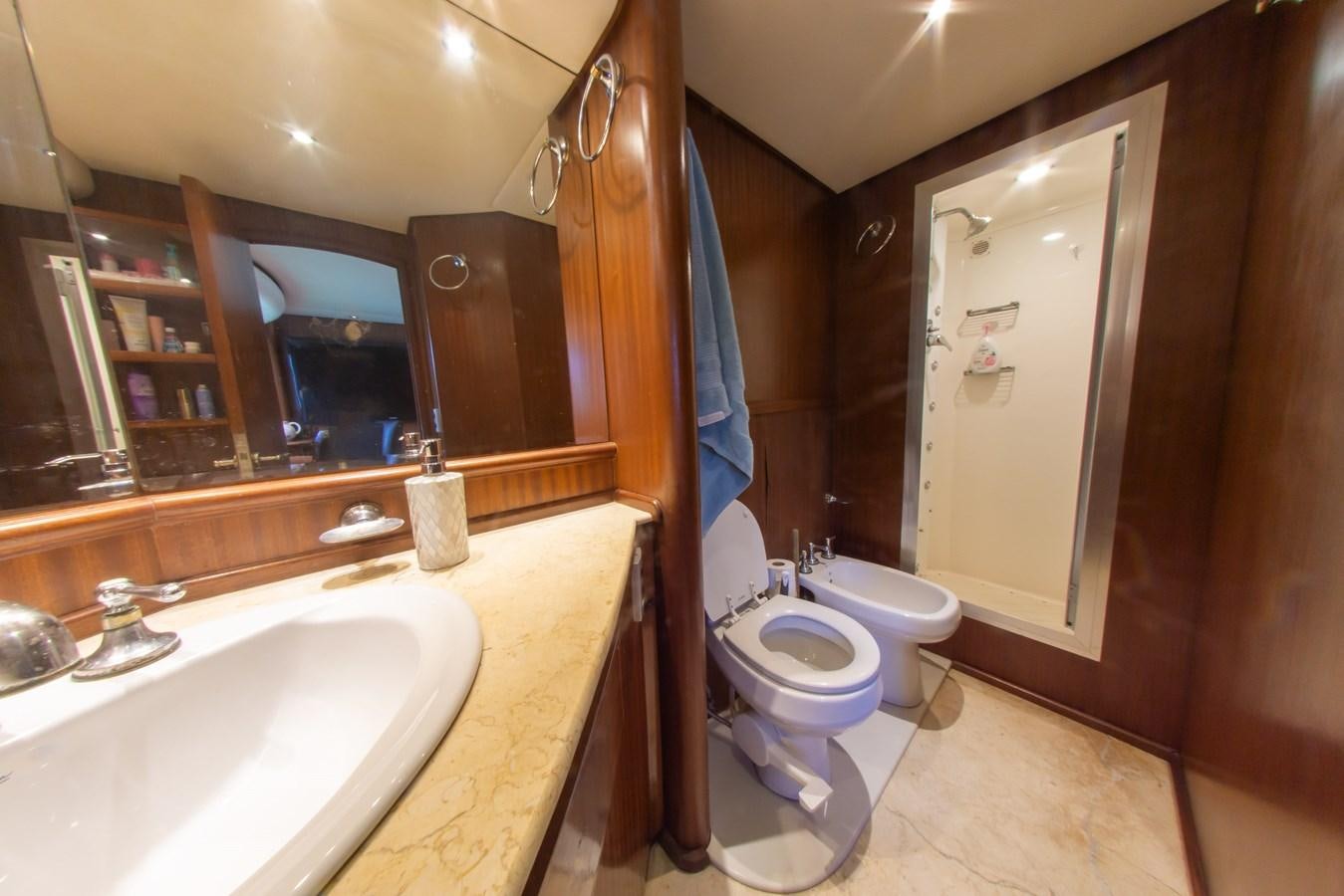 a bathroom with a sink toilet and a mirror aboard OLD SPORT II Yacht for Sale